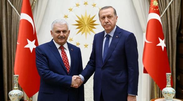 الرئيس التركي رجب طيب أردوغان مصافحاً رئيس حكومته الجديد بن علي يلدريم(أرشيف)