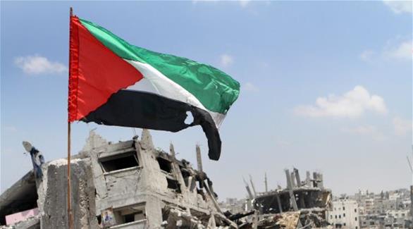 العلم الفلسطيني وسط المباني المدمرة في غزة (أرشيف)