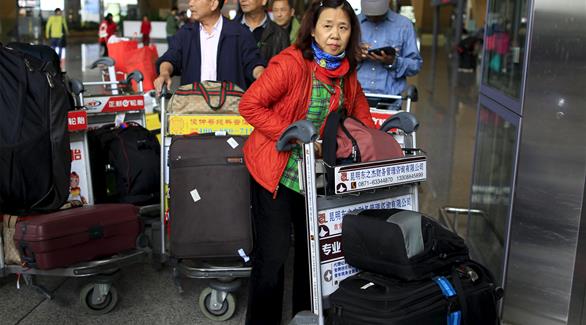 سياح صينيين عادوا من نيبال في مطار كونمينغ جانغشوي الدولي (رويترز)