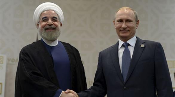 الرئيس الروسي فلاديمير بوتين يصافح الرئيس حسن روحاني في إيران خلال لقائهما في اوفا  بروسيا 9 يوليو  2015(أرشيف)
