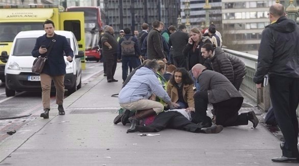مواطنون يحاولون اسعاف مصاب على جسر وستمنستر في لندن.(أرشيف)