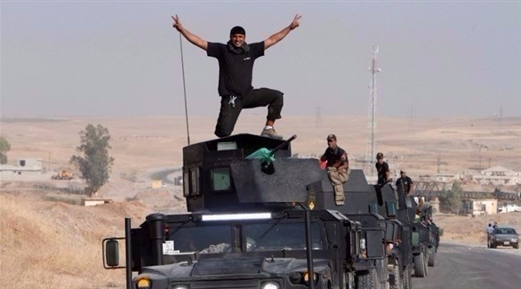 جنود عراقيون يحتفلون بتحرير الموصل.(أرشيف)