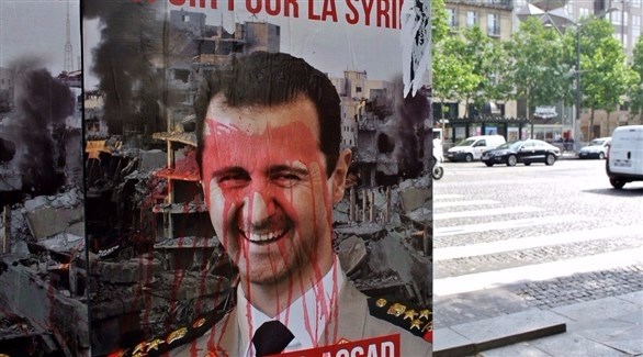 صورة مشوهة لرئيس النظام السوري مرفوعة في باريس (أرشيف / أ ف ب)