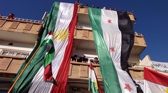 علما الأكراد والمعارضة السورية على أحد المباني في شمال سوريا.(أرشيف)