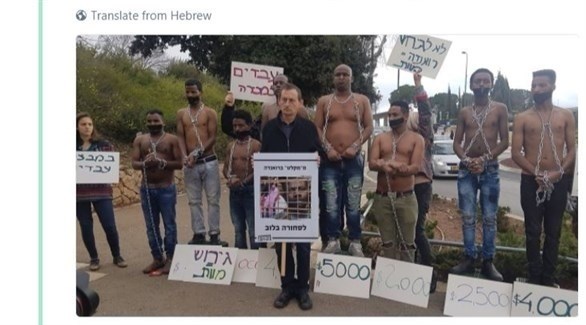 عضو الكنيست دوف حنين يلتقط صورة مع لاجئين أفارقة في إسرائيل (تويتر)