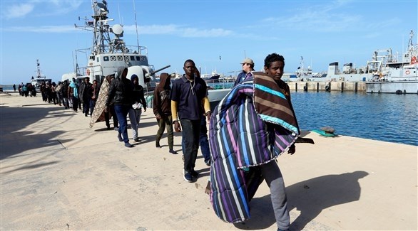 مهاجرون في ميناء طرابلس في ليبيا (رويترز)