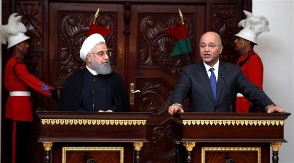 الرئيسان العراقي برهم صالح والإيراني حسن روحاني في بغداد الإثنين.(رويترز)