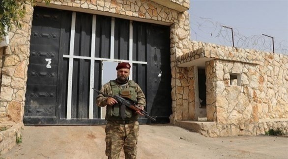 عسكري يعمل ضمن الميليشيات الموالية لأنقرة يقف أمام سجن تركي في سوريا (أرشيف)