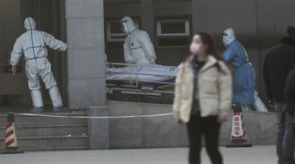 مسعفون ينقلون مصاباً بفيروس كورونا في الصين إلى الحجز الصحي (أرشيف)