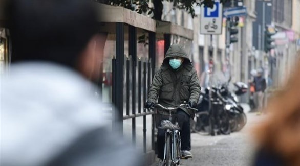 سائق دراجة في الحي الصيني بميلانو الإيطالية (أ ف ب)
