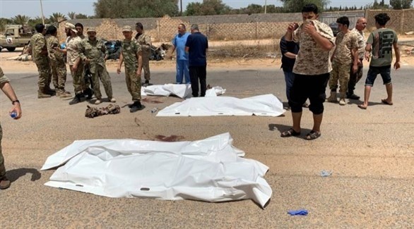 مسلحون من ميليشيات الوفاق حول جُثث قتلى في ترهونة الليبية (أرشيف)