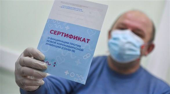 روسي يرفع شهادة تطعيمه ضد كورونا (أرشيف)