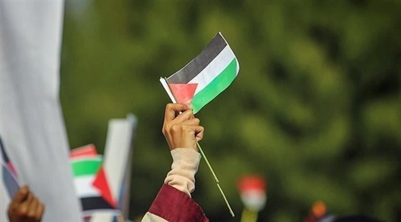 أشخاص يرفعون الأعلام الفلسطينية (أرشيف)
