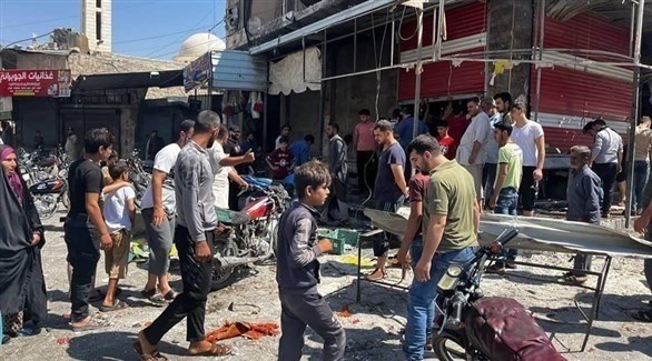 سوريون في موقع الهجوم الصاروخي في مدينة الباب (تويتر)