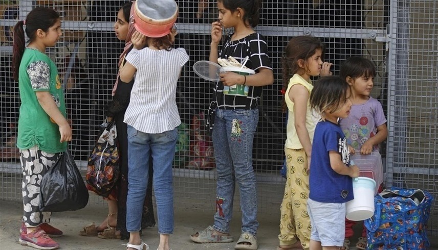 أطفال عراقيون أمام مركز لتوزيع الطعام (أ ف ب)